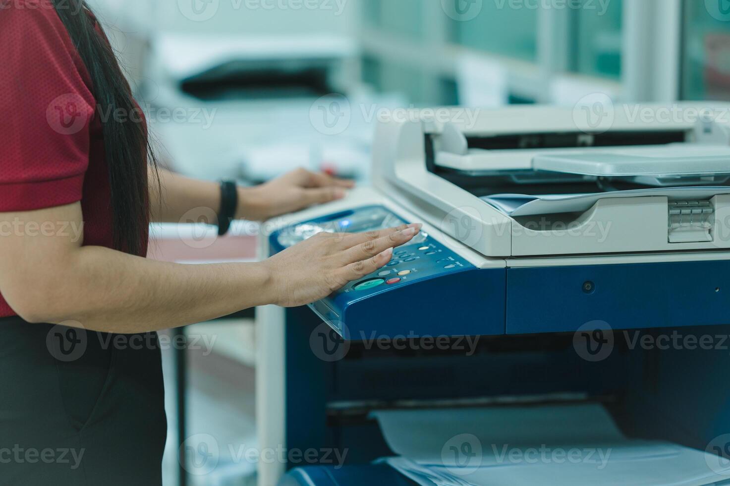 Employee woman is using a printer or Photocopier in office businesses, employees rely on advanced photocopier and printer technology as essential office equipment photo