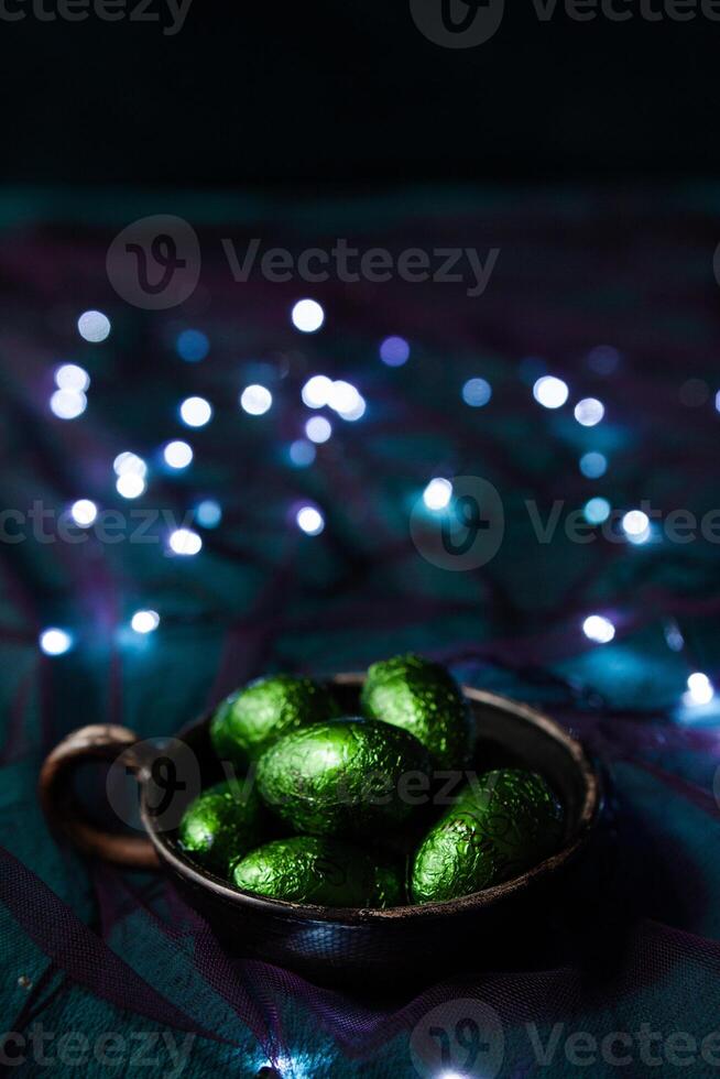 A plate of shiny green eggs among the garlands photo