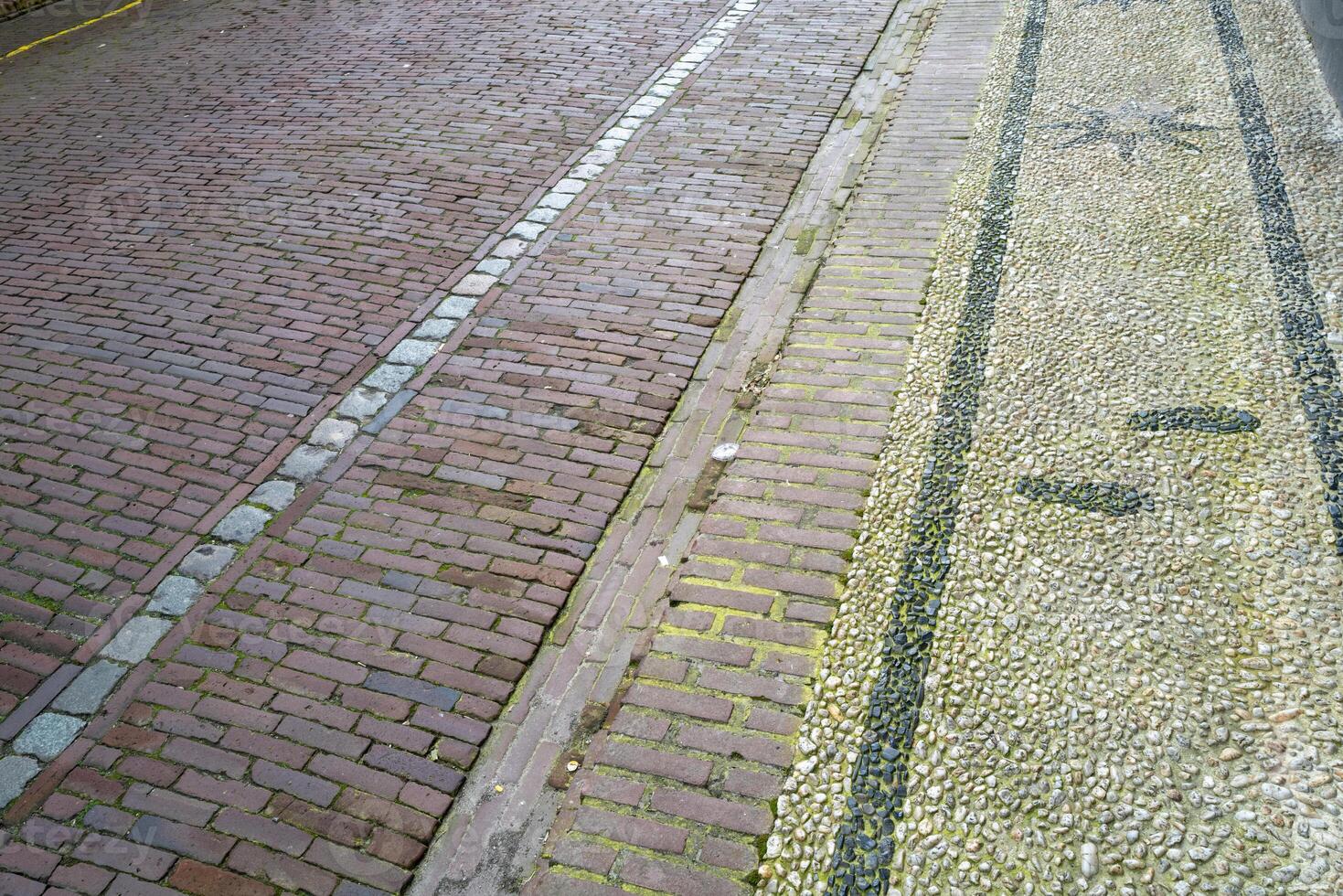 street and sidewalk with patterned paving stones photo