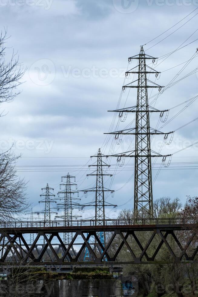 high voltage pylon in front of a cloudy sky photo