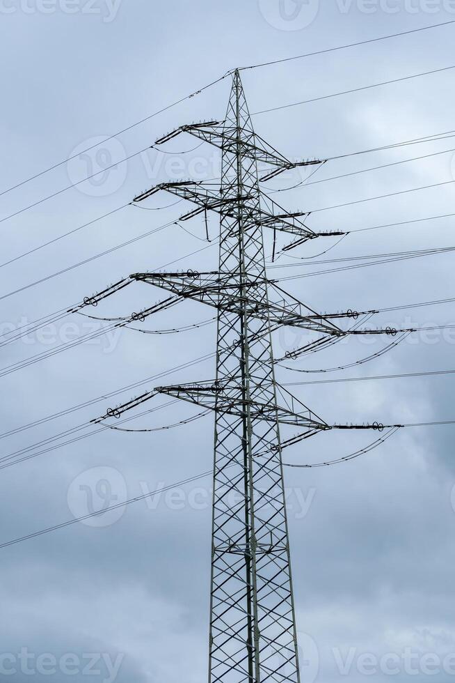 high voltage pylon in front of a cloudy sky photo