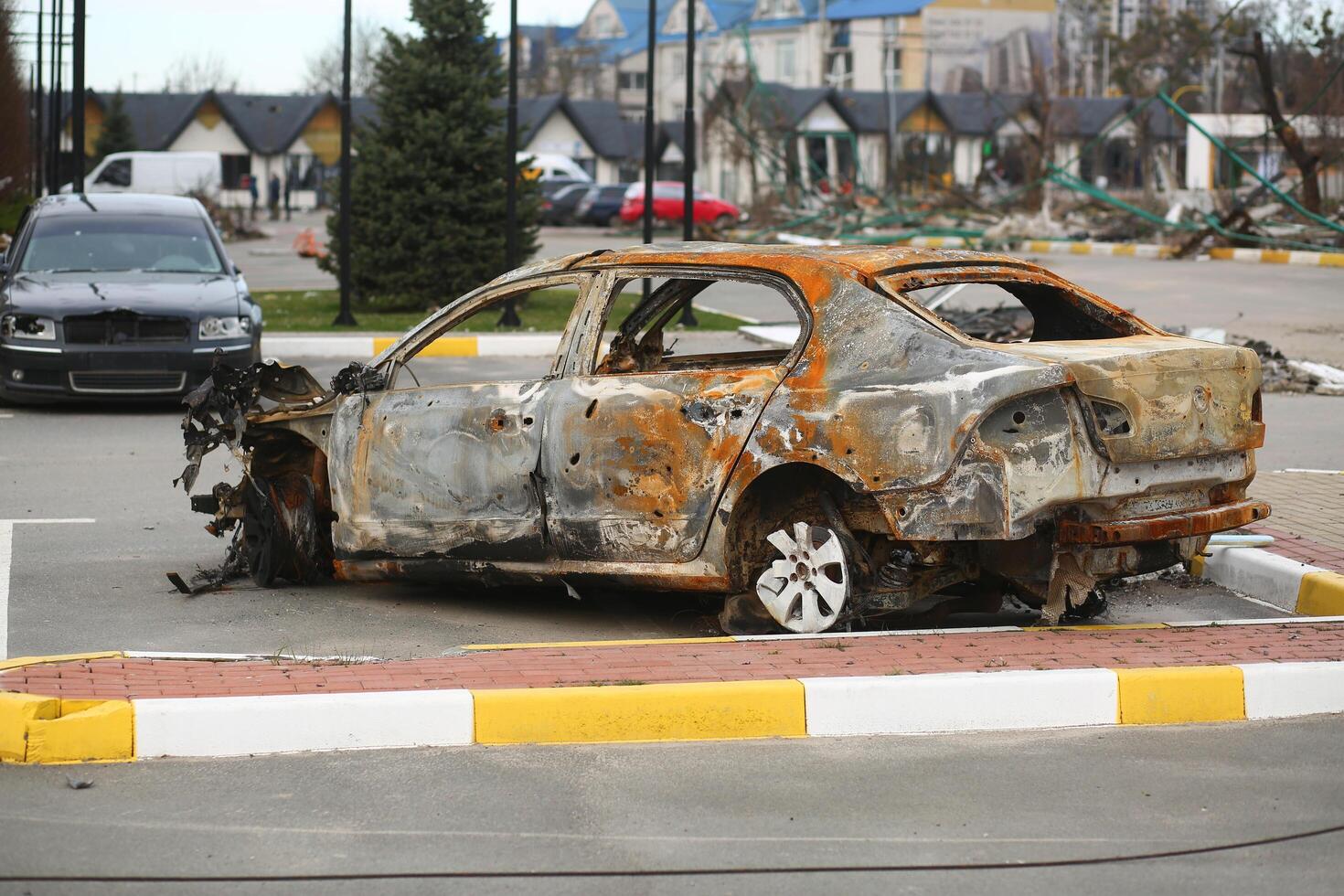 Bucha, Ukraine - April 12, 2022 Cars deliberately smashed by the russian army shooting and shelling in the streets of Bucha town photo