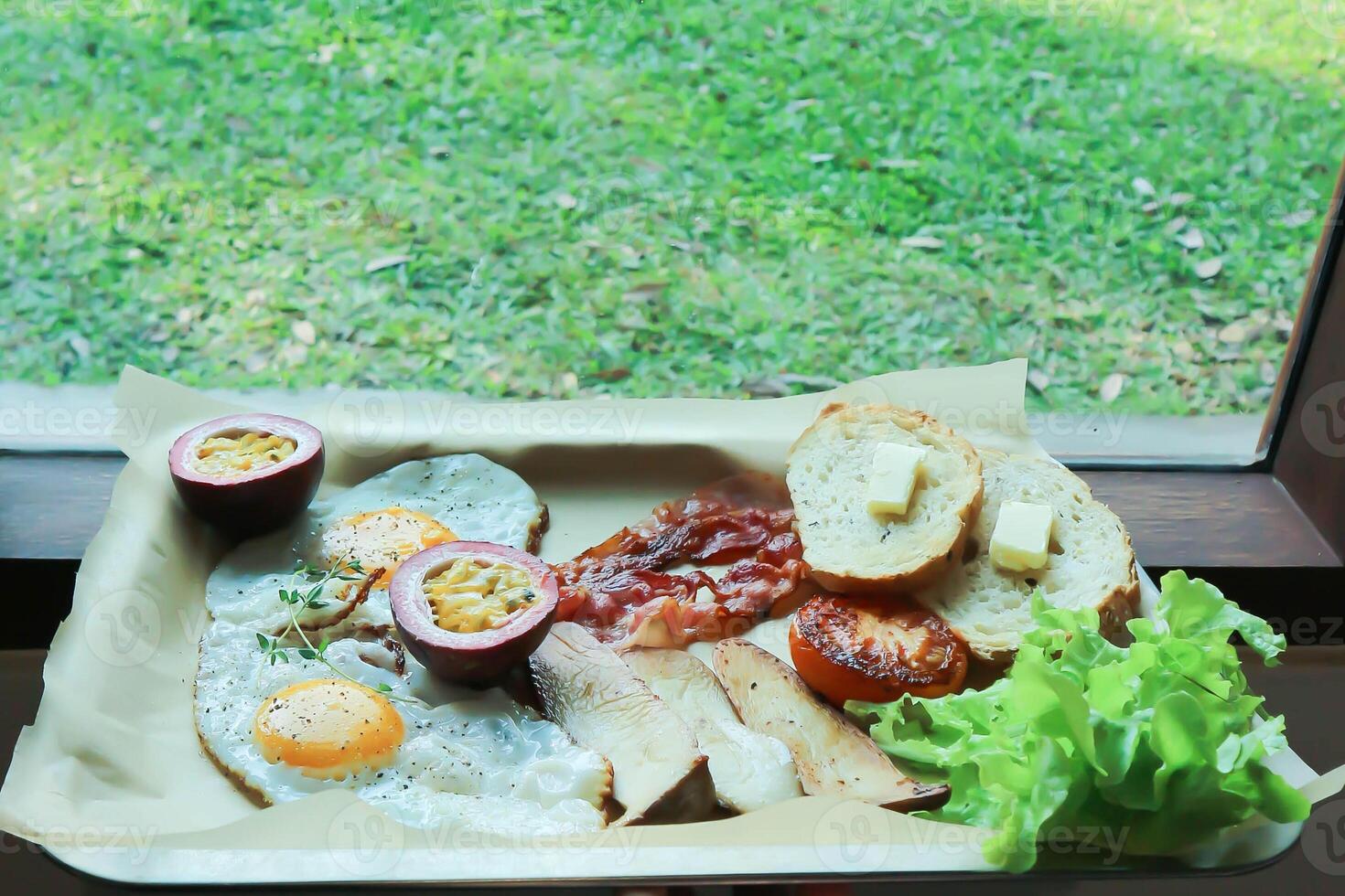 toast with bacon, fried egg and lettuce or sunny side up egg with bacon and  mushroom photo