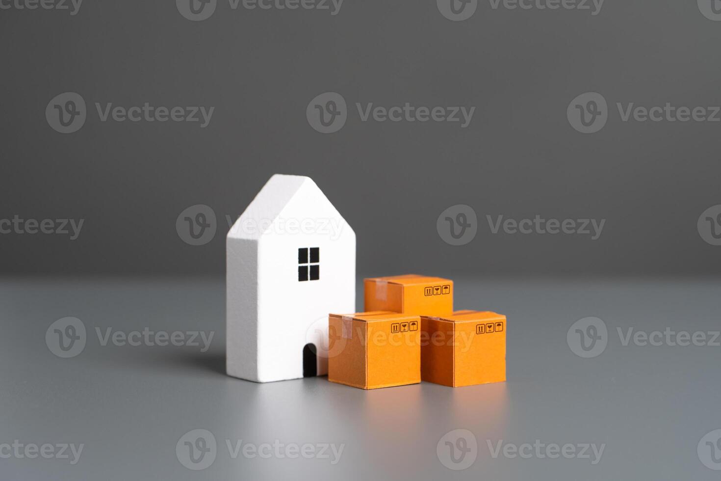 White house and boxes. House moving. Online orders. Home delivery photo