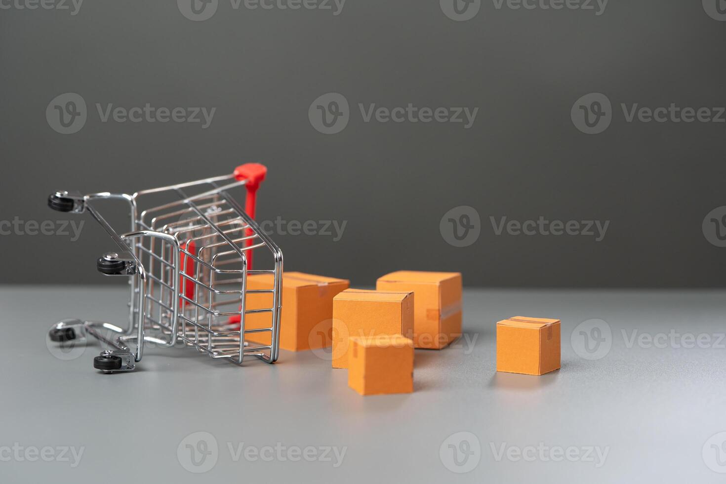 An overturned shopping cart with boxes of goods falling out. Fall in demand for goods. Decrease in purchasing power of buyers. Market research, marketing. photo