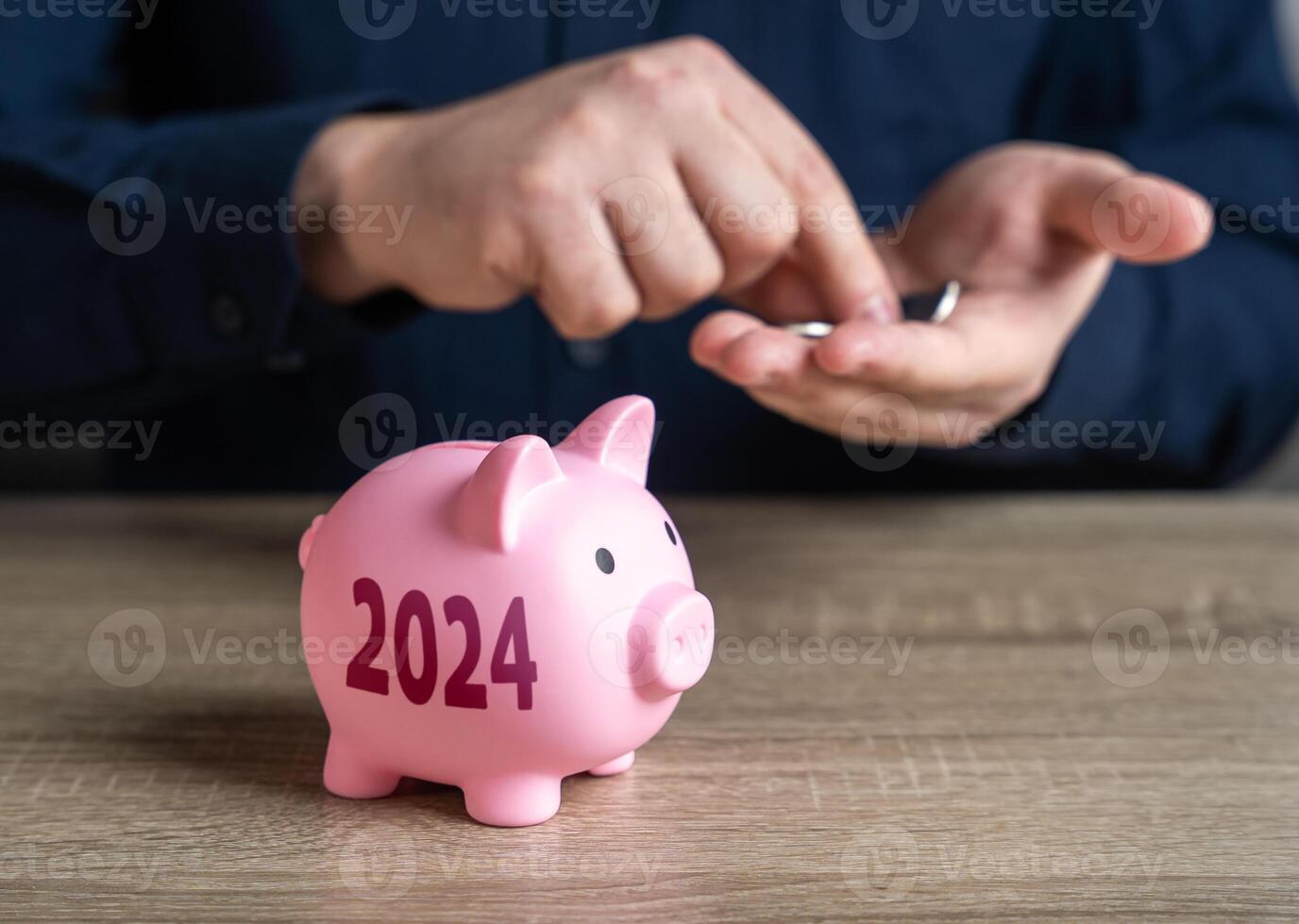 Piggy bank and 2024. Saving plans for the year ahead. Savings and investments. Collection of donations. Bank deposit. Raise funds for your dream. Reduce costs. Save for retirement. Accumulating money. photo