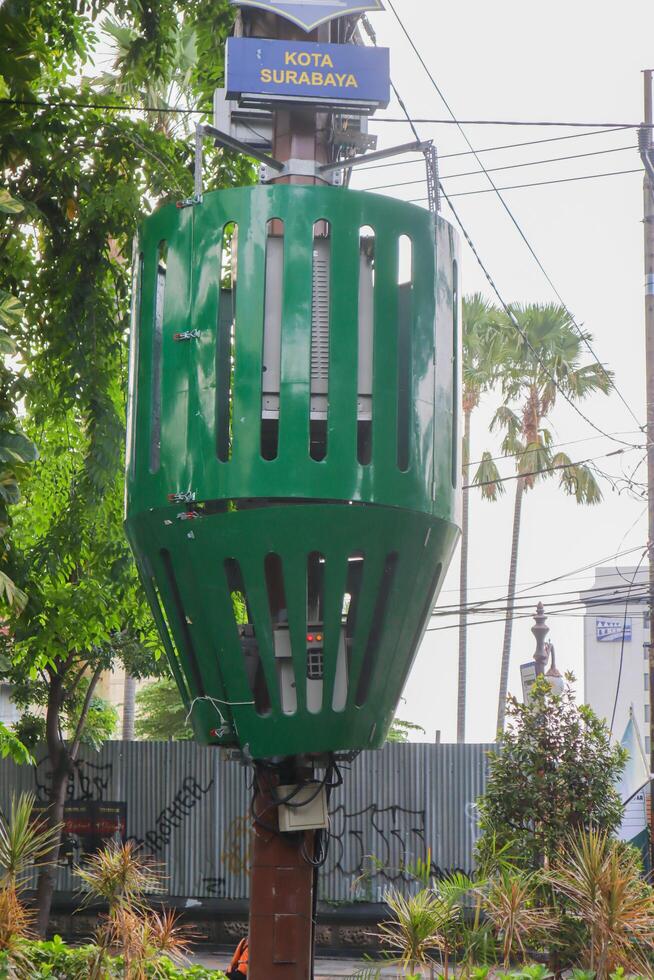 a electric transformer on the pole with protective iron. surabaya, indonesia - 6 maret 2024 photo