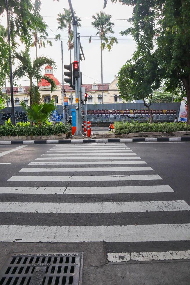 a zebracross for pedestrian to cross. surabaya, indonesia - 6 maret 2024 photo