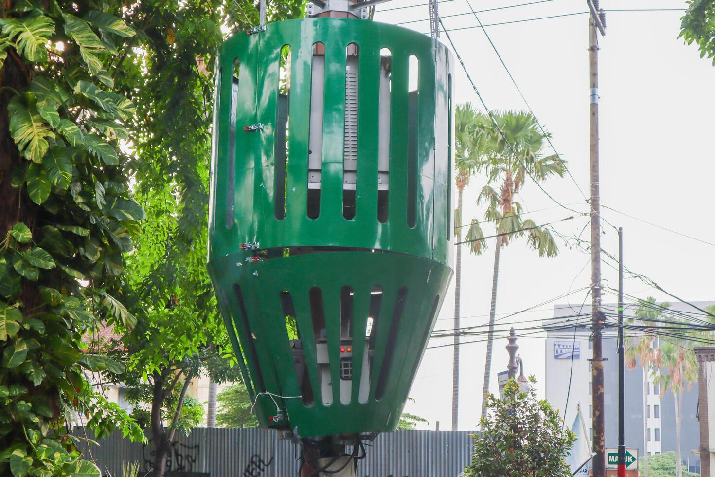 a electric transformer on the pole with protective iron. surabaya, indonesia - 6 maret 2024 photo