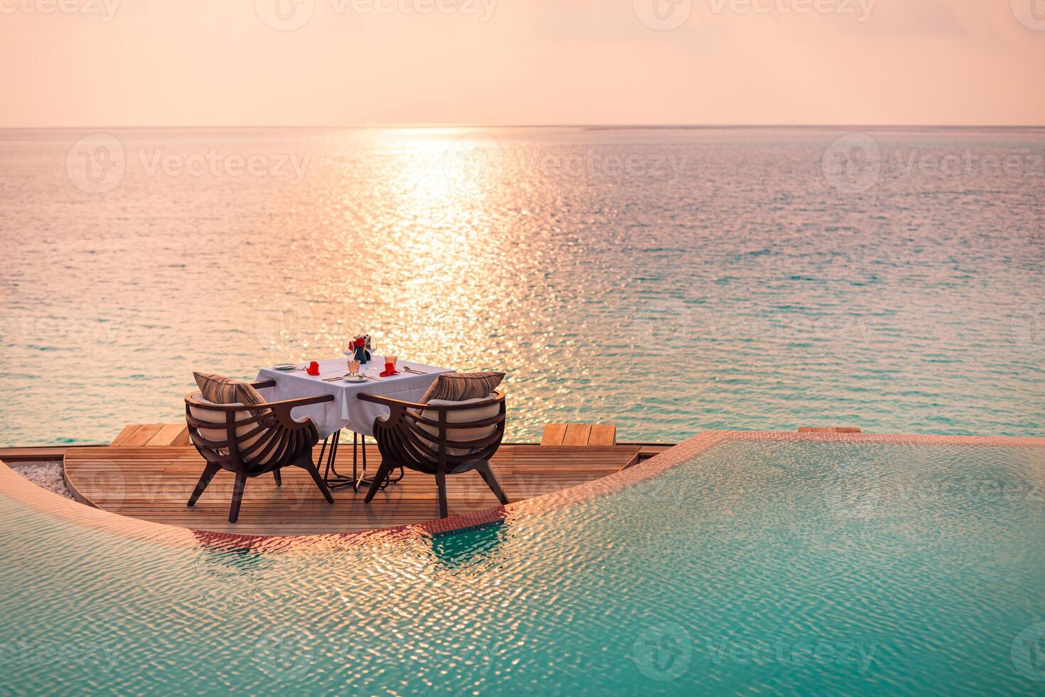 marina ver debajo puesta de sol ligero con comida mesa con infinito piscina alrededor. romántico tranquilo Aléjate para dos, Pareja concepto. sillas, comida y romance. lujo destino comida, Luna de miel modelo foto