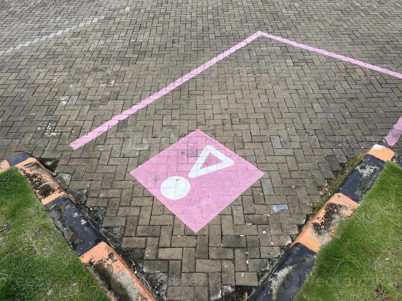 Paving block parking with unique pink parking lines and symbol in rest areas photo