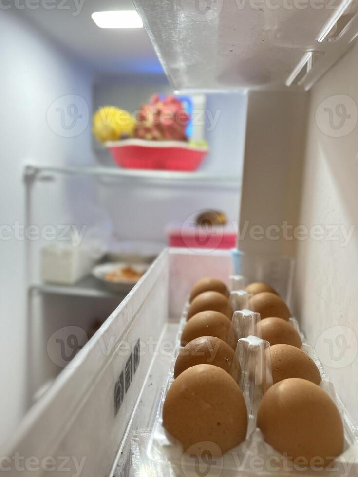 Fresh fruits and eggs in the refrigerator photo