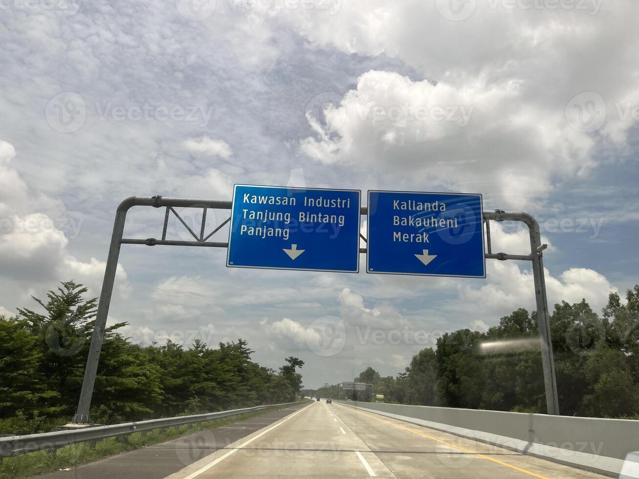 Highways in Indonesia with bright, dark and cloudy skies in the background photo