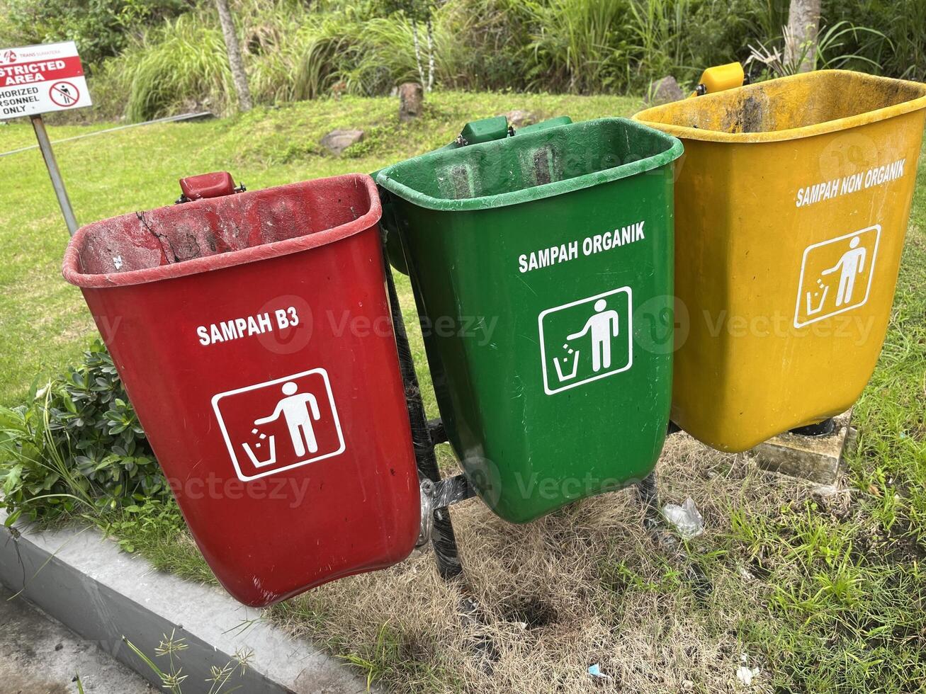 Inorganic organic waste bins of various colors in public places and parking lots photo