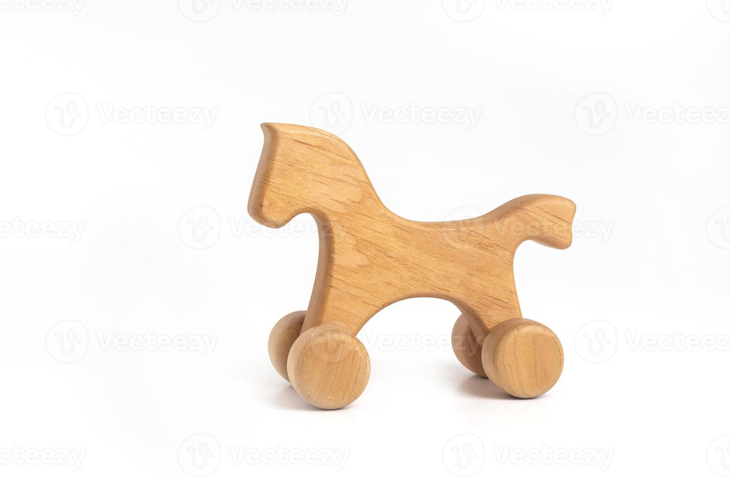 Toy - handmade wooden horse on wheels isolated on white background photo