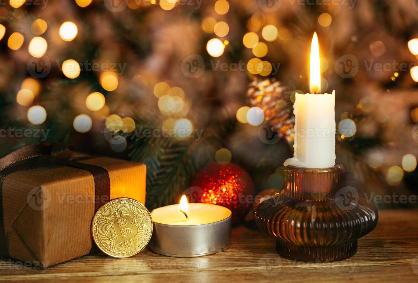 Gold coin bitcoin stands near the christmas decorations on the table with gift box, a spruce branch and candle. Beautiful Christmas, new year background with bitcoin. Digital currency. photo