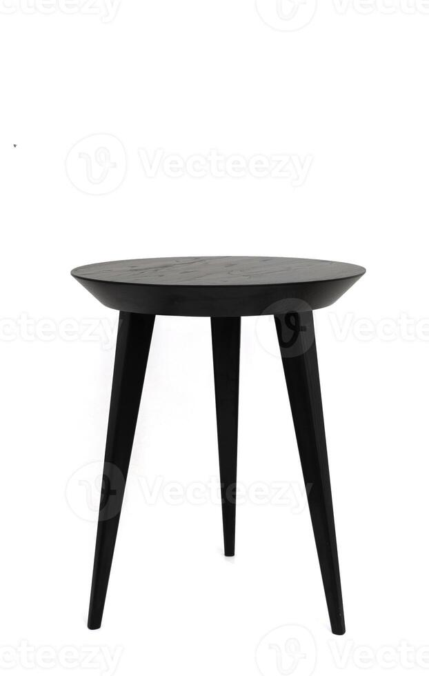 Round black wooden coffee table on three legs with a beautiful wood texture. Isolated on a white background photo