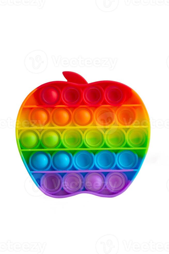 Rainbow push pop it bubble sensory fidget toy in form of Apple, trendy antistress sensory toy. Anti anxiety and stress game Isolated on white background. photo