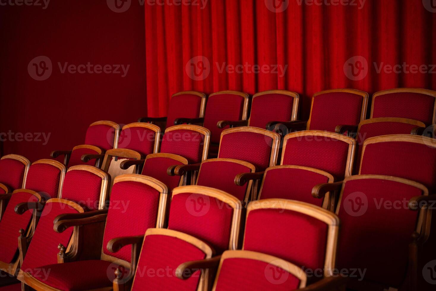 red empty seats for spectators in the theater or cinema photo