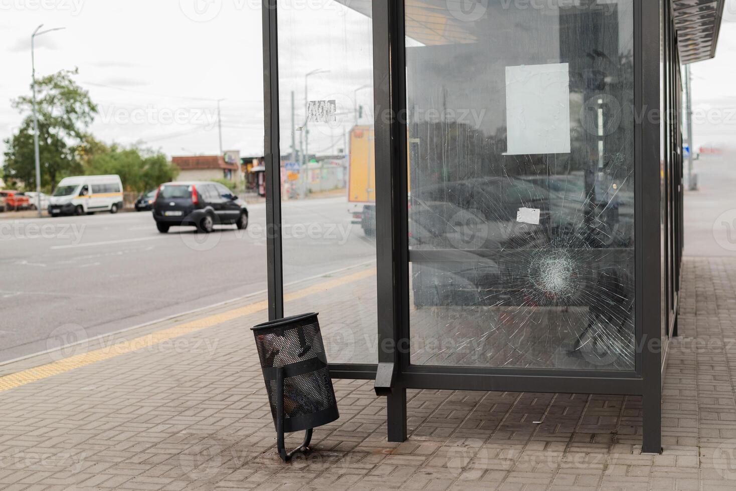 Broken glass at the bus stop. Public transport station vandalised by the glass windows. cracks of tempered glass photo