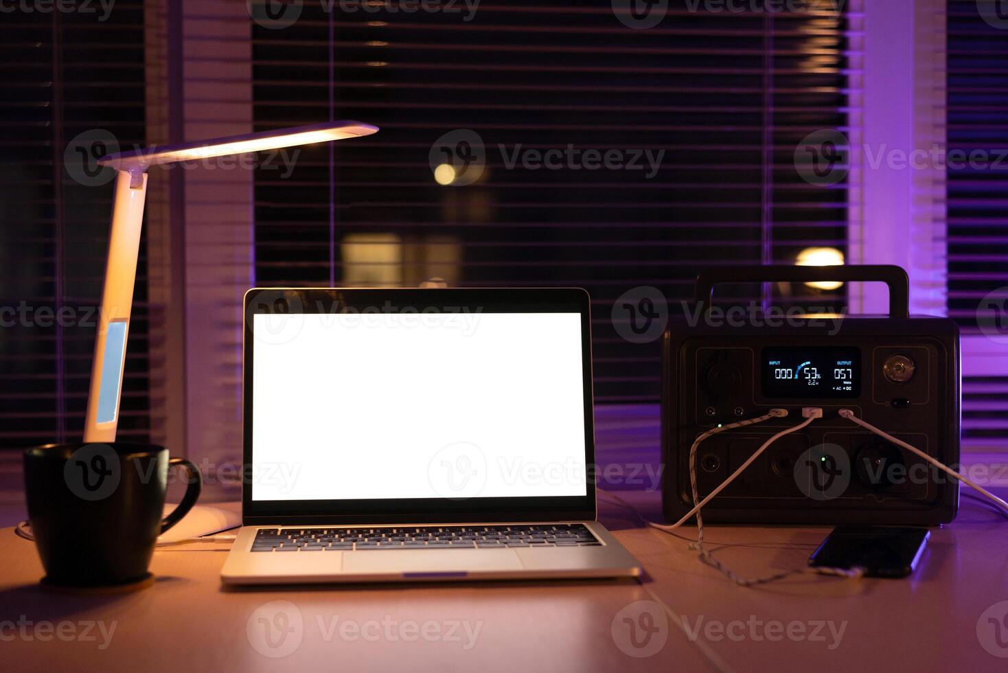 Charging station for laptop and desk lamp when there is no light during blackout. Generator power bank battery in the absence of electricity. at home table photo