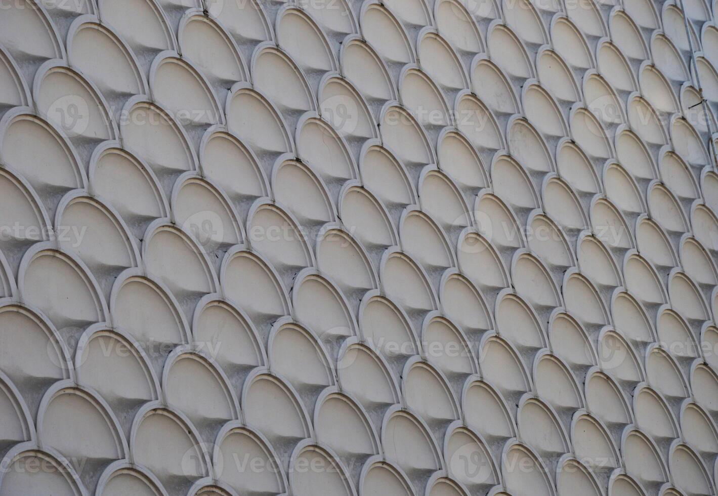 Texture of gray marble stone wall facade, tiles with round elements. photo