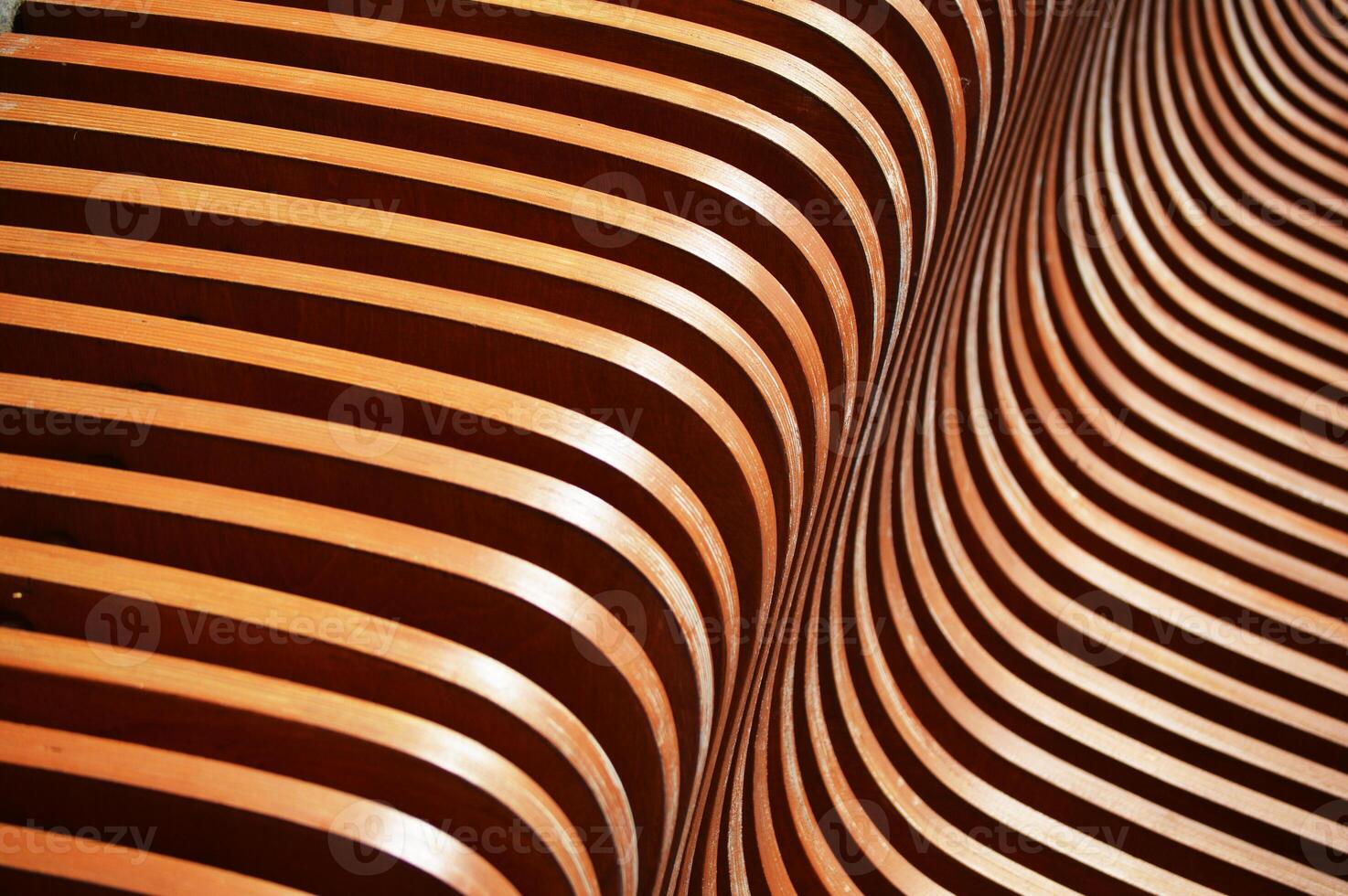 Brown curved wooden slats, planks. Smooth angle of the decorative element of the bench. Abstract background. photo