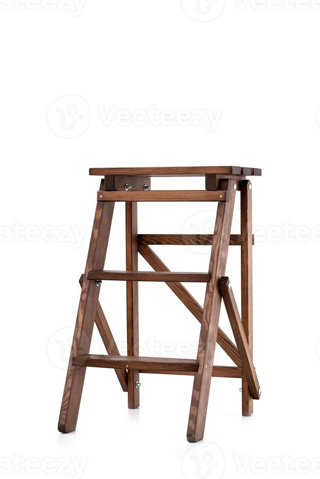 Small old-style decorative folding wooden ladder isolated on white background. wooden stairs photo