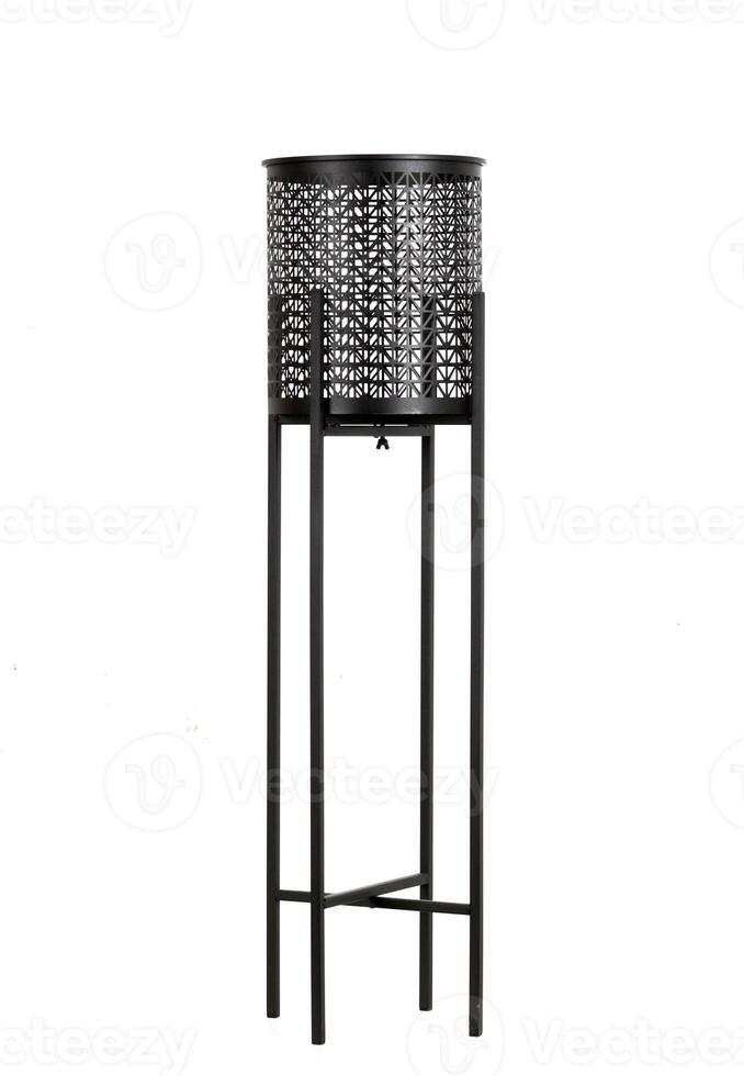 Black tall metal openwork planter on a stand, flower pot isolated photo