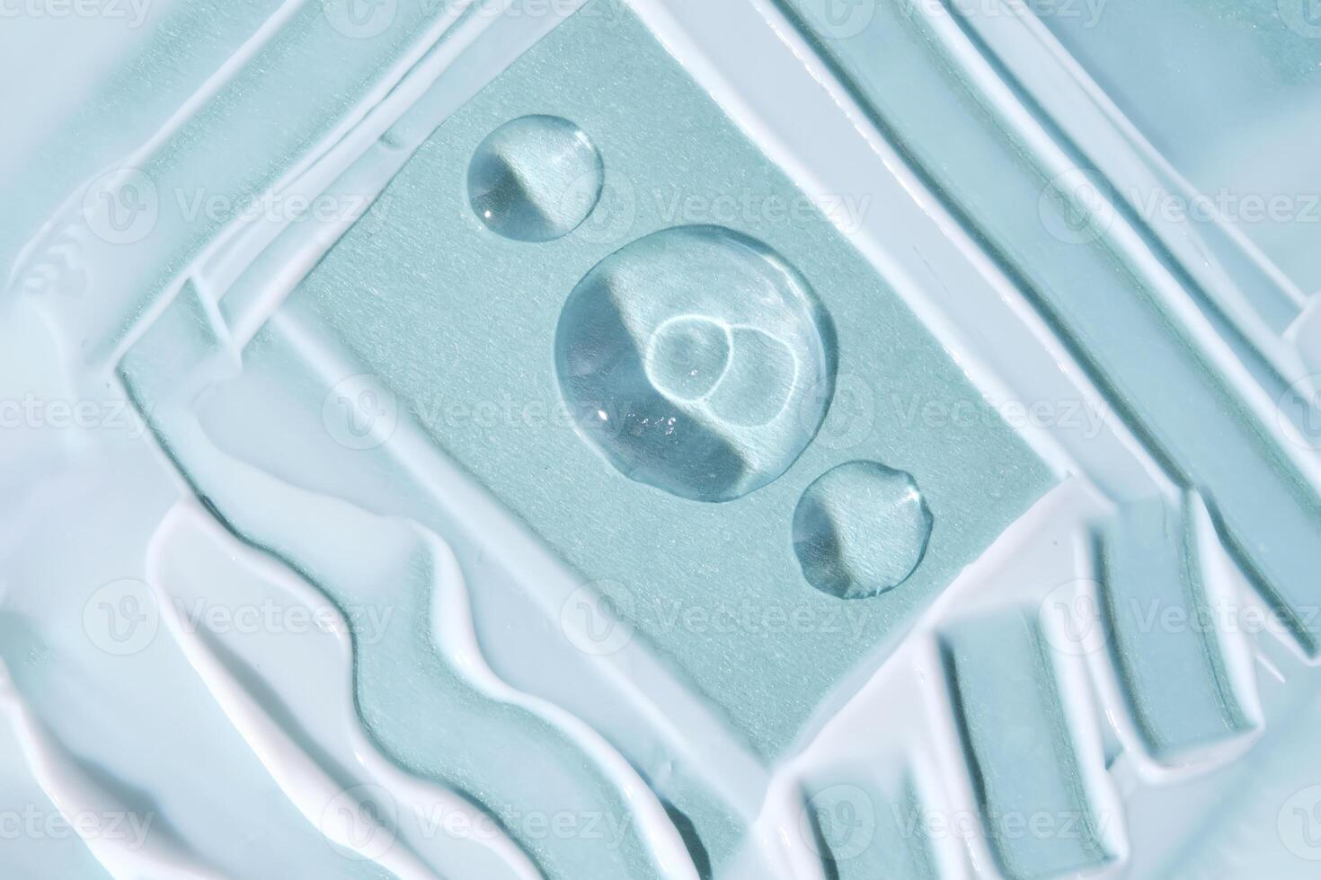 A smear with drops of serum on a blue background. photo