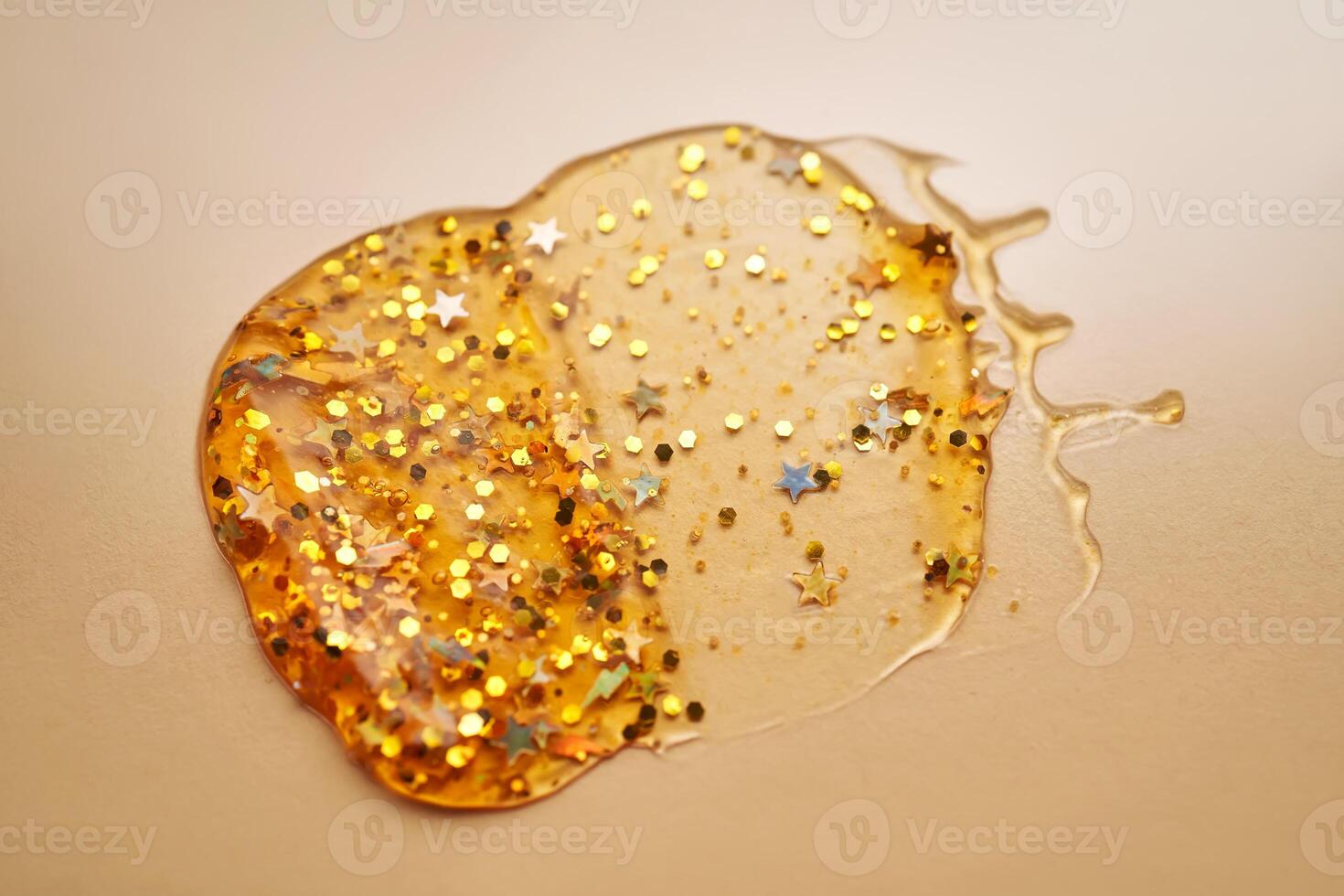 Cosmetic gel with glitter on a beige background. photo
