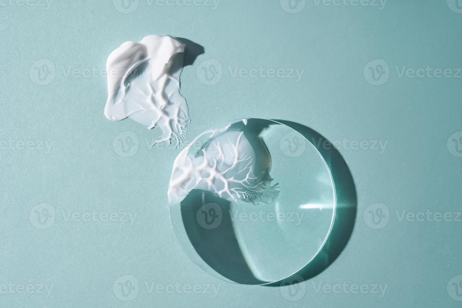 A smear of cream against a background of glass prisms on a blue background. photo