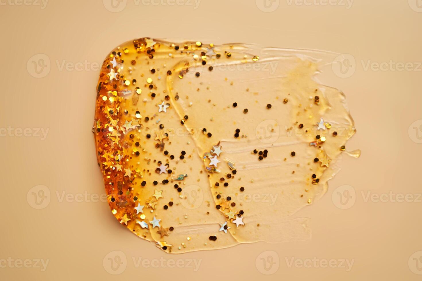 Cosmetic gel with glitter on a beige background. photo