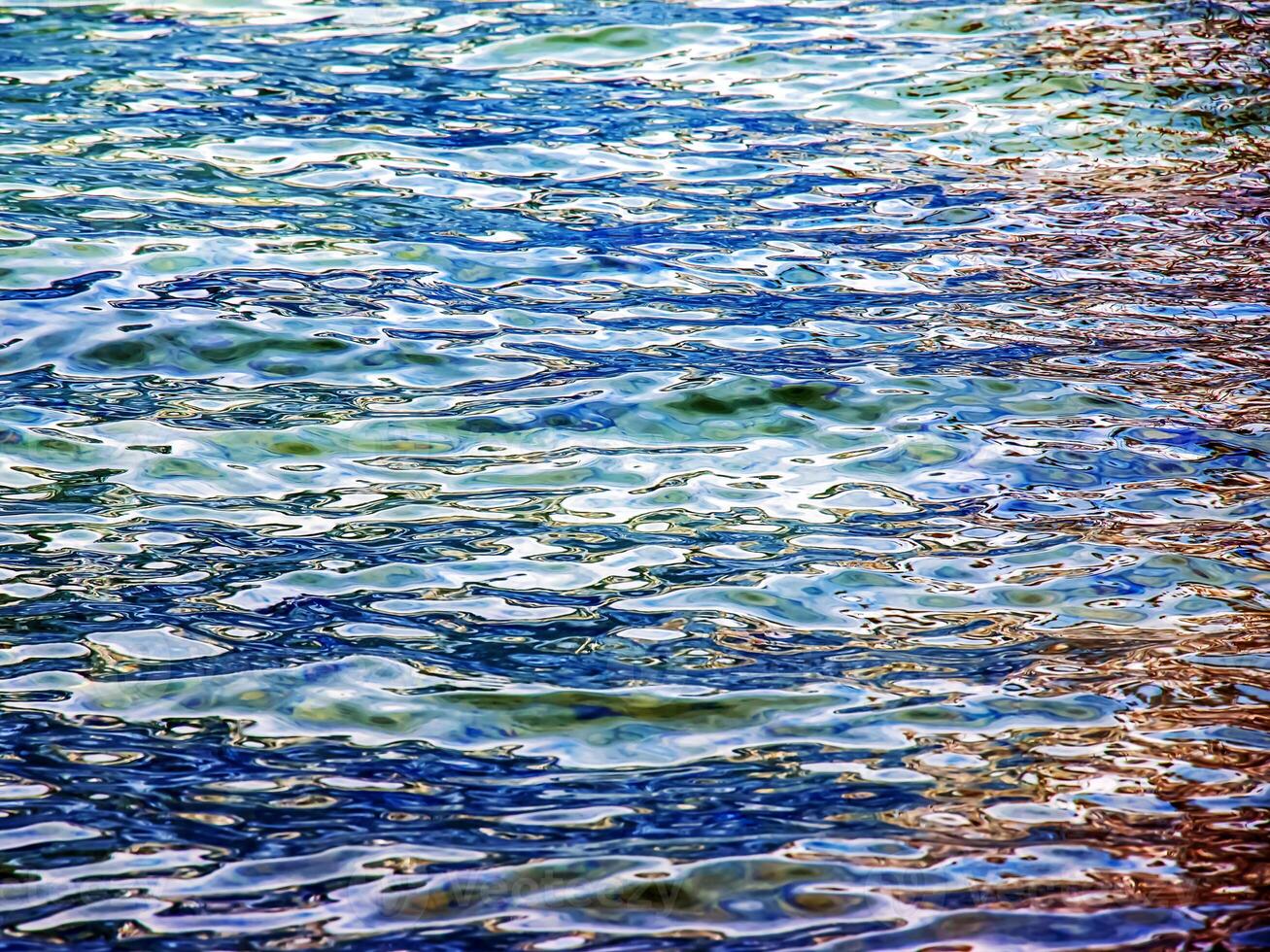 Background of the water of Lake Traunsee in the coastal area. Colorful texture of stones under water. photo