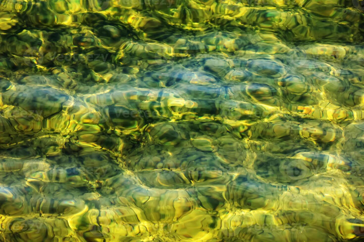 Background of the water of Lake Traunsee in the coastal area. Colorful texture of stones under water. photo