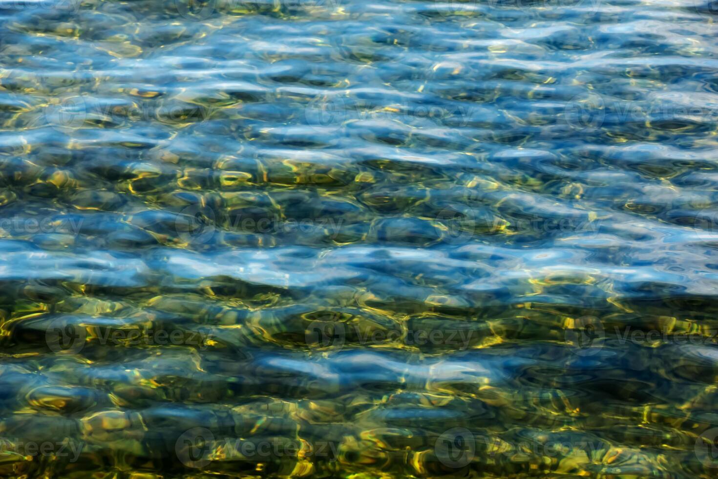 Background of the water of Lake Traunsee in the coastal area. Colorful texture of stones under water. photo