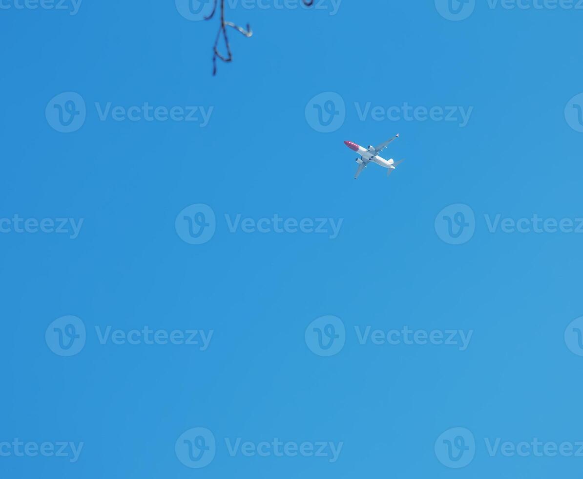 Airplane against a background of blue sky on a sunny day. photo