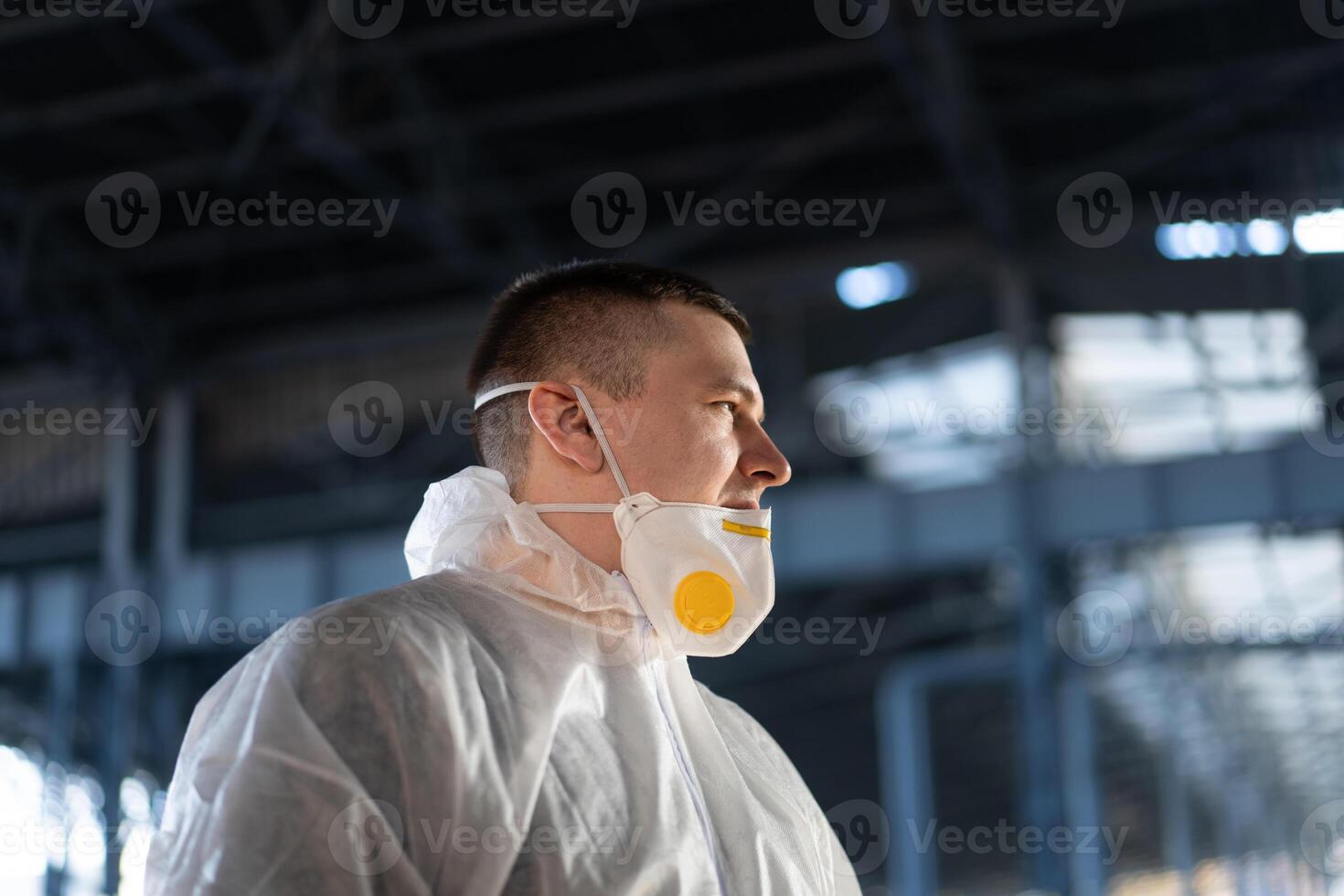 COVID-19 coronavirus doctor standing hospital parking dressed white protective overalls hazmat suit. photo