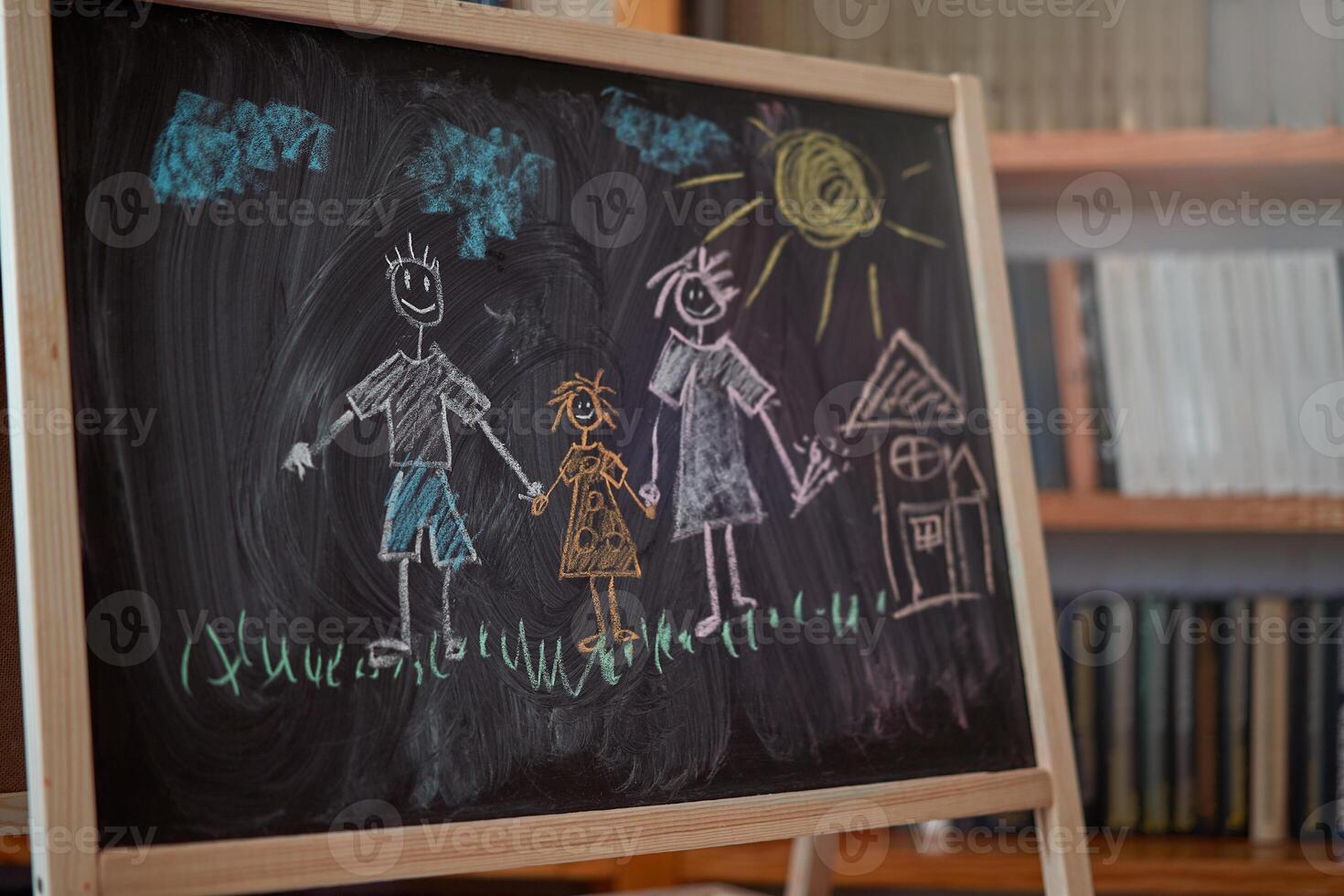 Children multicolored chalk drawing on blackboard photo