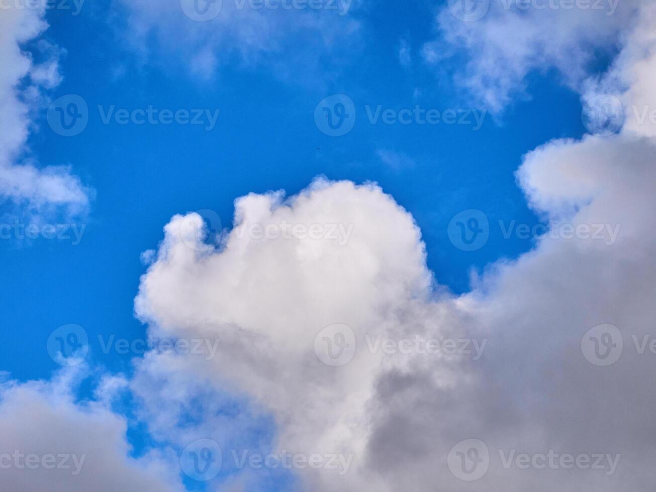 White fluffy clouds in the deep blue sky. Heaven background photo