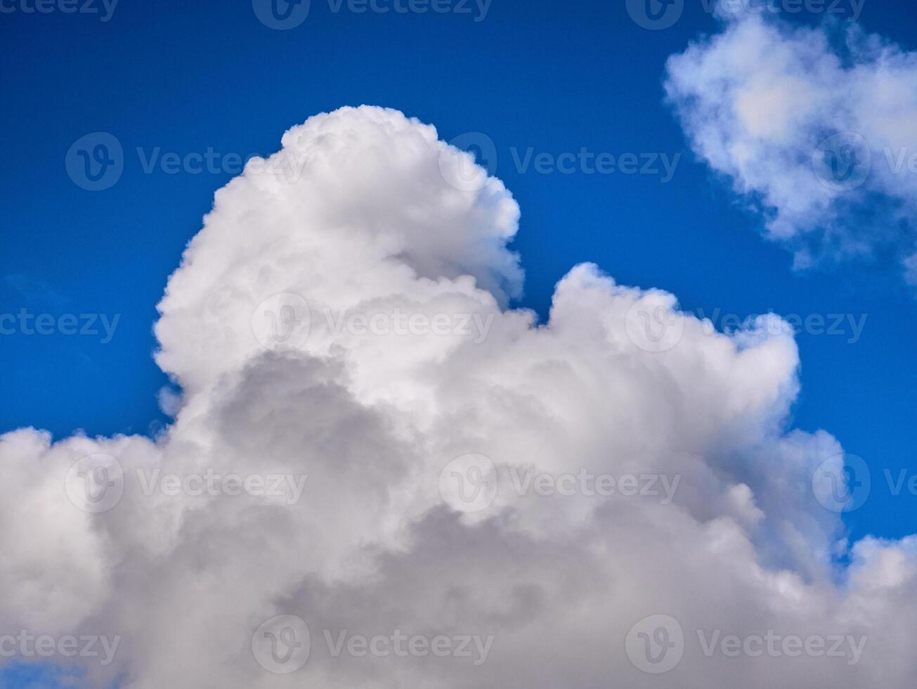 White fluffy clouds in the deep blue sky. Heaven background photo