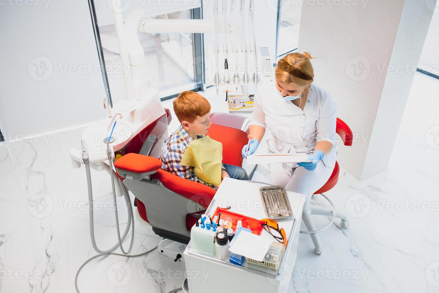 Female dentist and child in a dentist office photo