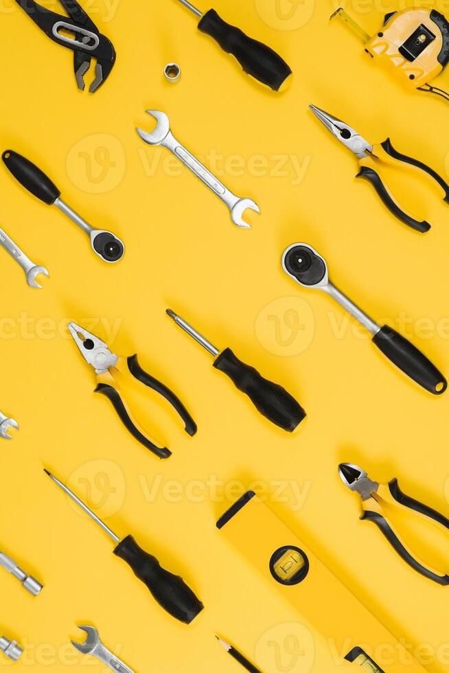 Set of various construction tools. Tools for home repair. Work at a construction site. On a yellow background. Flatly. Flatlay photo