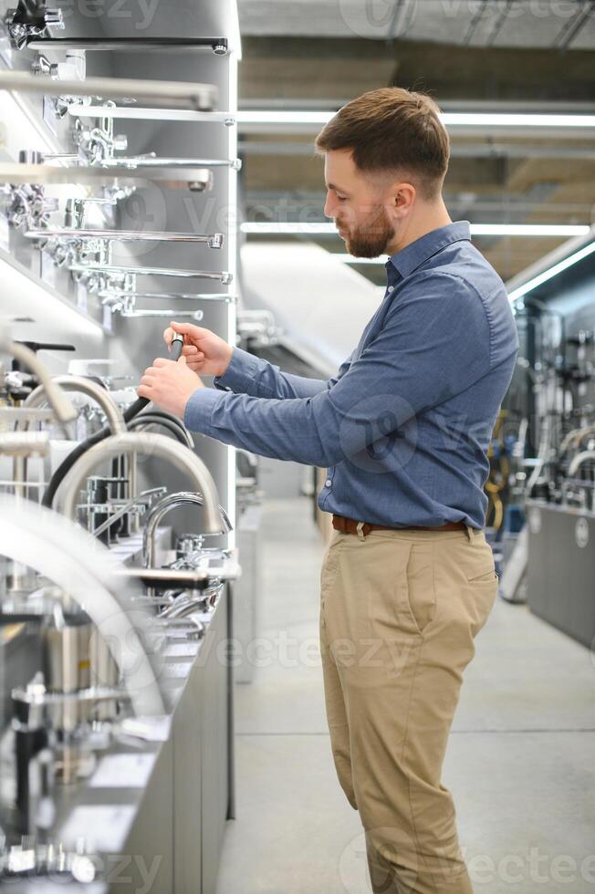 Man chooses a products in a sanitary ware store photo