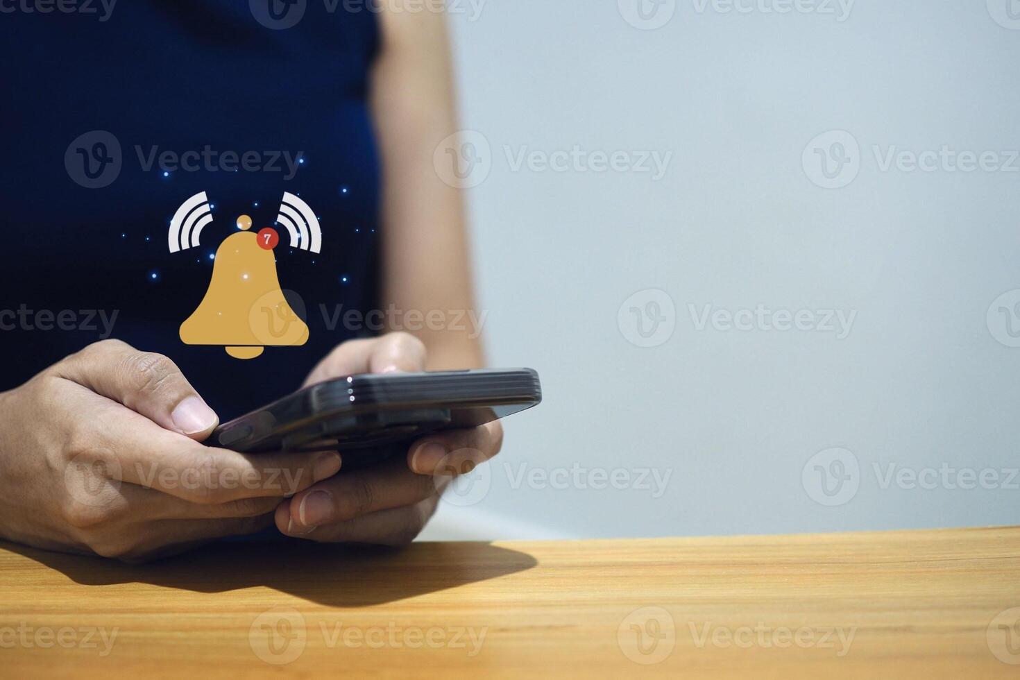 Businessman using smartphone with virtual bell notification, system notification or new email. photo