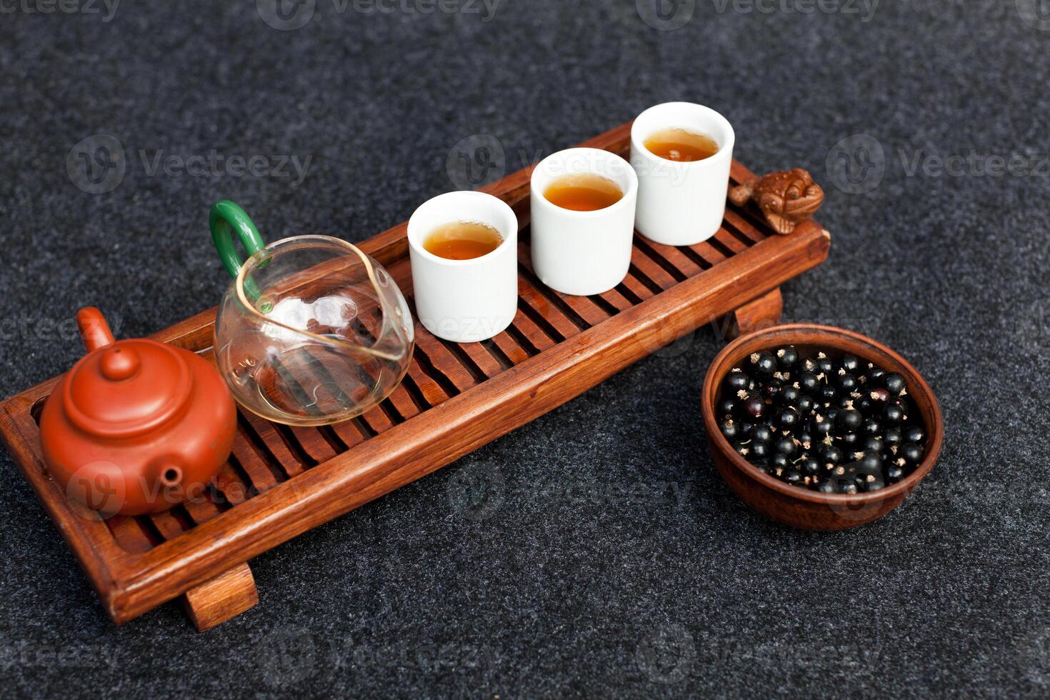 Traditional Chinese tea ceremony with black currant, fruit tea and healthy food. Photo without people. Summer natural vitamins and berries