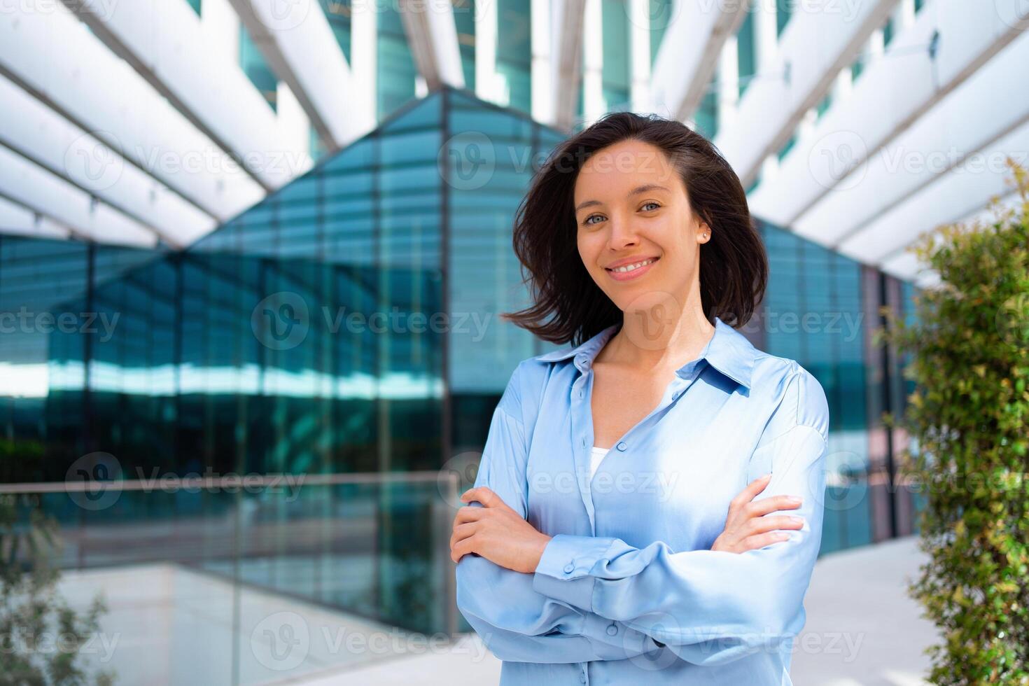 Businesswoman portrait. Caucasian female business person standing outdoor looking at camera close up face. Young beautiful modern business woman 30s years. Confidence employer smile photo