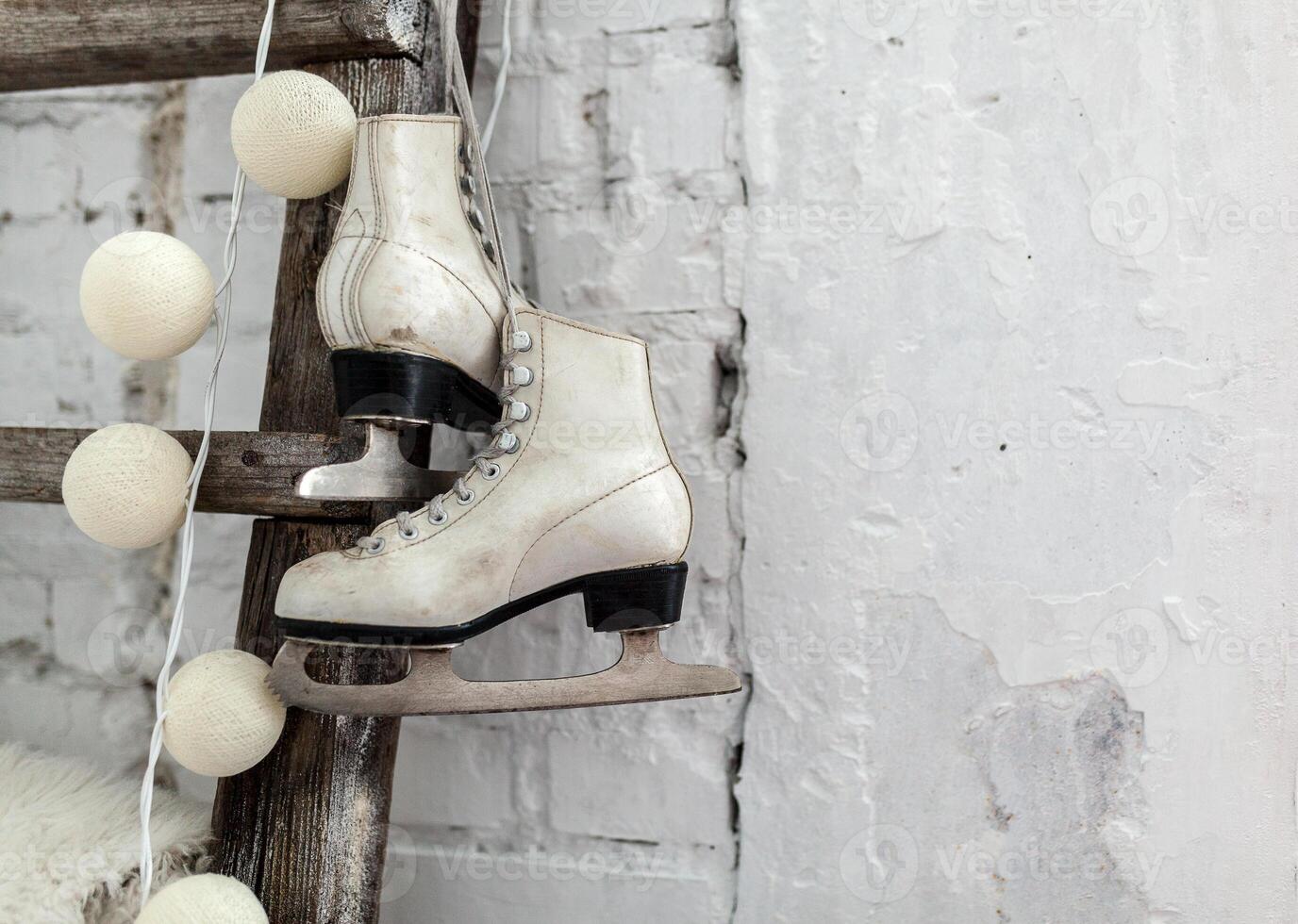 White skates at the wooden staircase Happy New year concept. Winter leisure photo