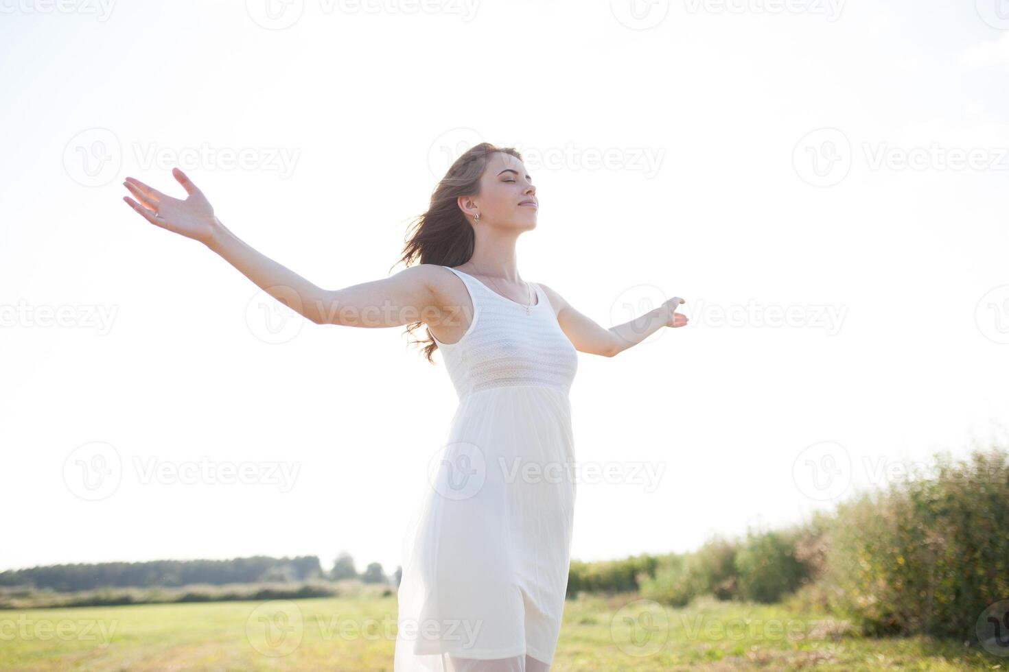 Beautiful caucasian girl walking on the field. Summer time day photo