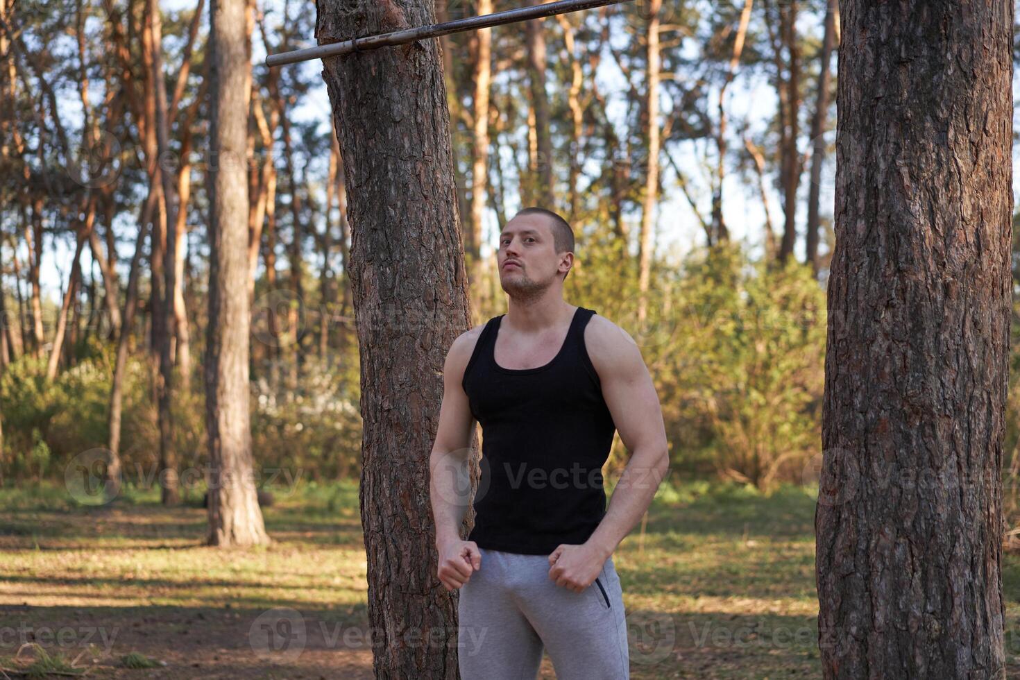 Handsome caucasian men pull-up outdoor workout cross training morning Pumping up arm exercising sports ground nature forest photo